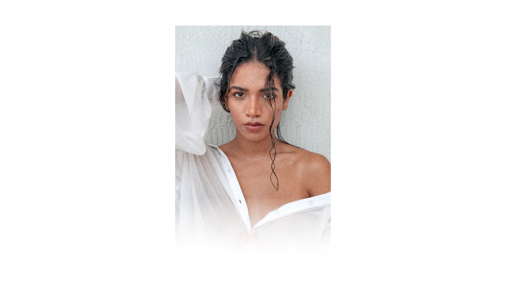 Wet-haired woman in an open sheer white shirt